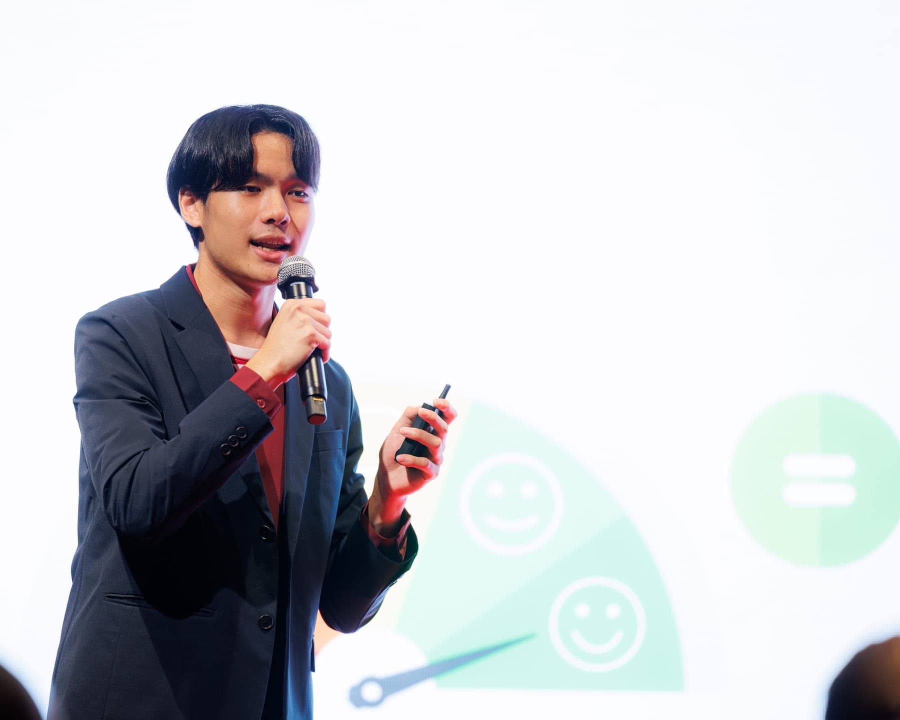 Rachata speaking on stage